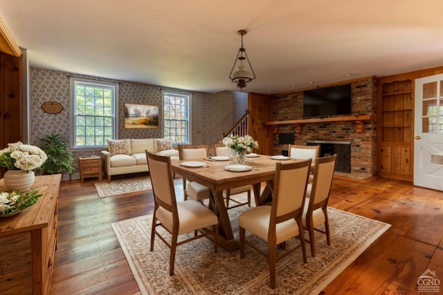 dining room featuring dark hardwood / wood-style flooring and a fireplace