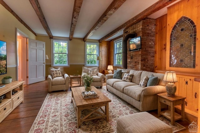 sitting room featuring beamed ceiling and wood-type flooring