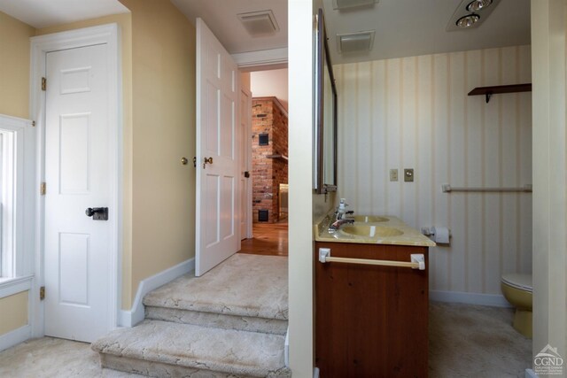 bathroom featuring vanity and toilet