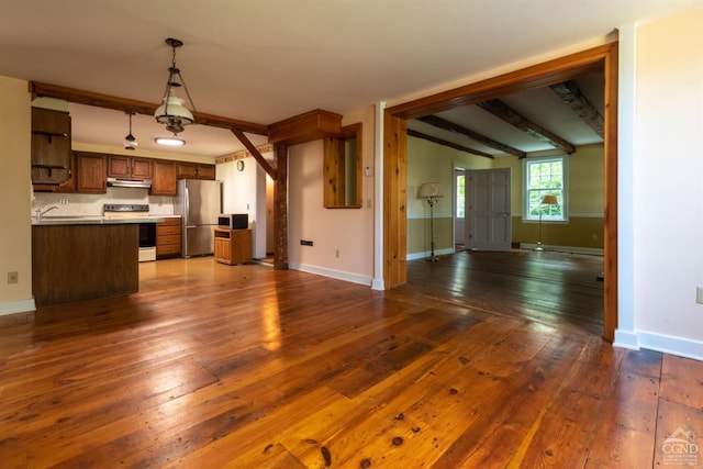 kitchen featuring white electric range oven, stainless steel fridge, dark wood-type flooring, and beam ceiling