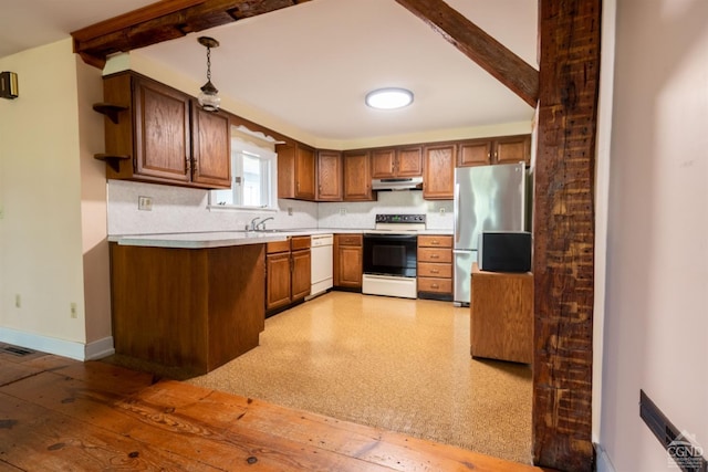 kitchen featuring beam ceiling, sink, decorative light fixtures, and white appliances