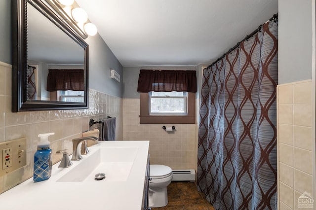 bathroom with vanity, tile walls, toilet, and a baseboard radiator