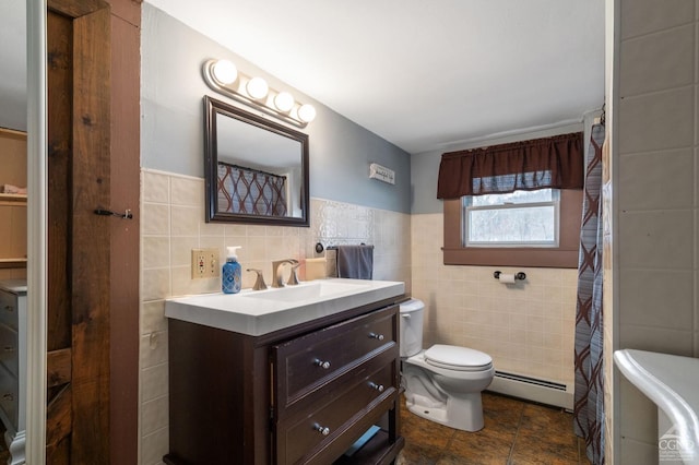 bathroom with toilet, a baseboard heating unit, a shower with shower curtain, tile walls, and vanity