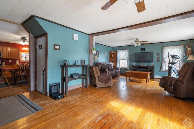 living room with light wood-style flooring, baseboards, and a ceiling fan