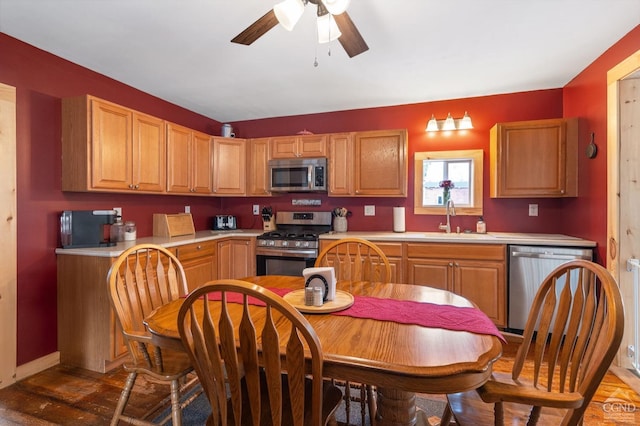 kitchen featuring a sink, light countertops, ceiling fan, and stainless steel appliances