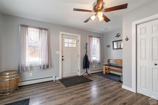 entrance foyer with dark wood-style flooring, a ceiling fan, baseboards, and a baseboard radiator