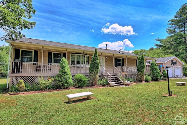 ranch-style house with an outbuilding, a front lawn, covered porch, and a garage