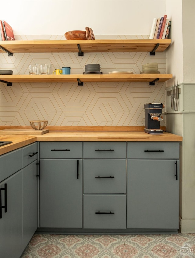 bar featuring wooden counters and tasteful backsplash