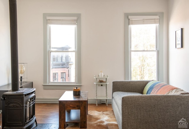 living area with hardwood / wood-style flooring and a healthy amount of sunlight