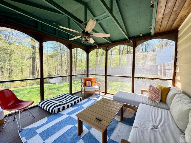 sunroom with an outdoor hangout area, beamed ceiling, and a ceiling fan