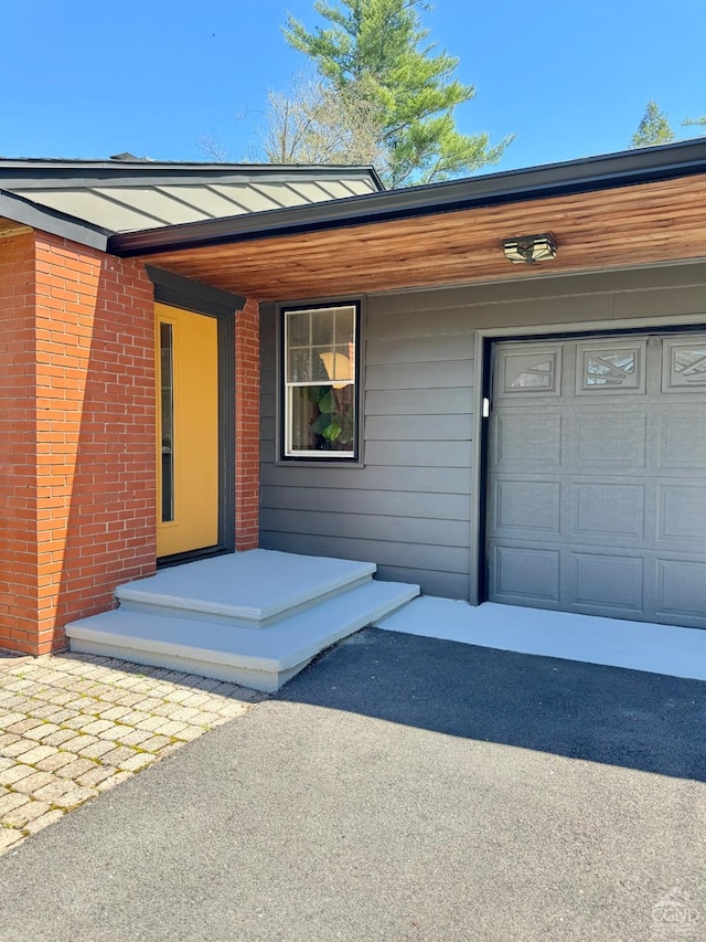 view of exterior entry featuring a garage