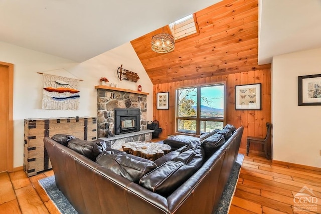 living room featuring light hardwood / wood-style floors, high vaulted ceiling, and wooden walls