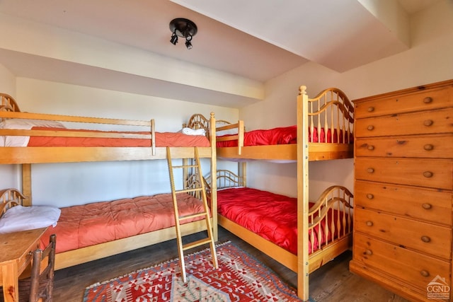 bedroom with dark hardwood / wood-style flooring