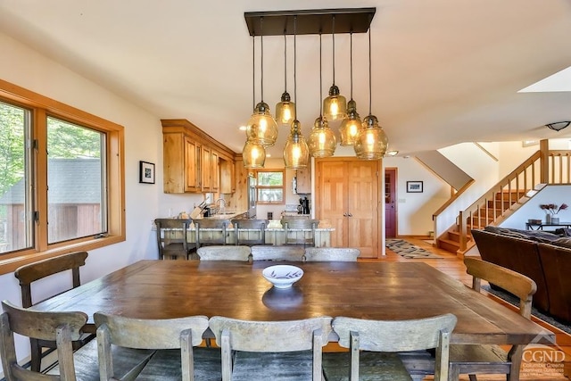 dining space with sink and light wood-type flooring