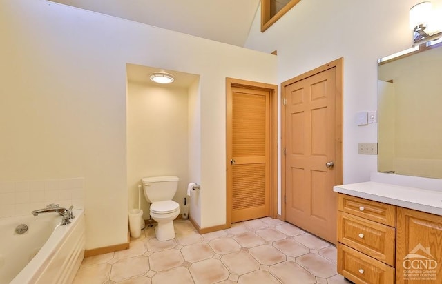 bathroom featuring a washtub, vanity, toilet, and vaulted ceiling