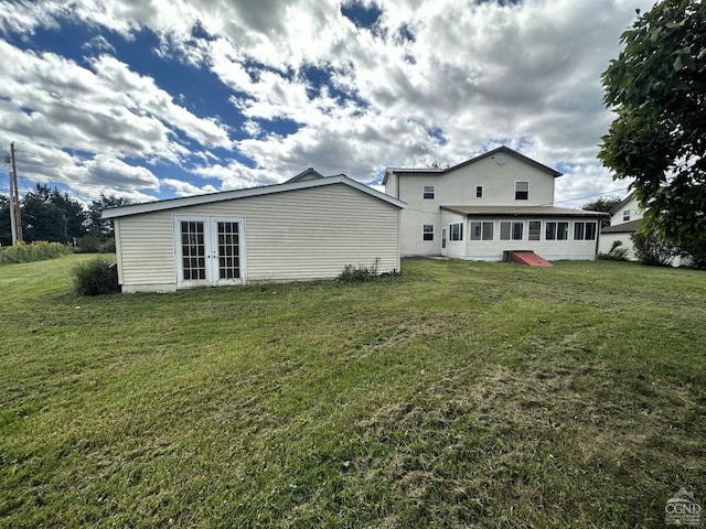 rear view of property with a yard and french doors