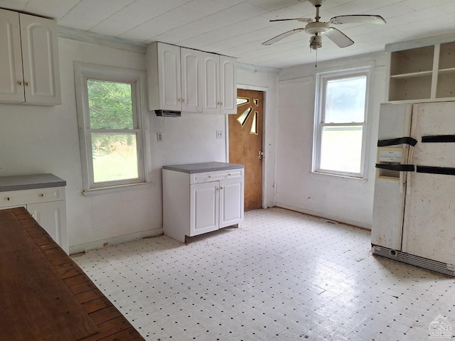 kitchen featuring white cabinets, white fridge, and ceiling fan