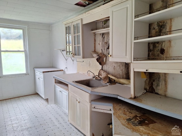 kitchen featuring white cabinetry and sink