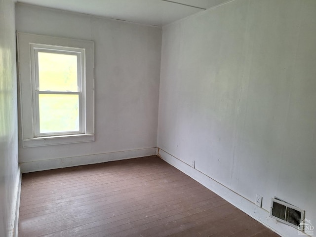 spare room featuring dark hardwood / wood-style flooring