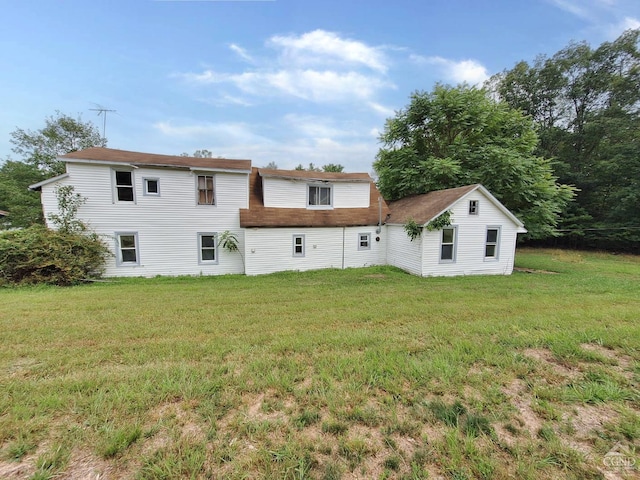 back of property featuring a lawn