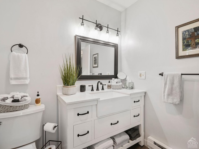 bathroom with vanity, a baseboard radiator, and toilet