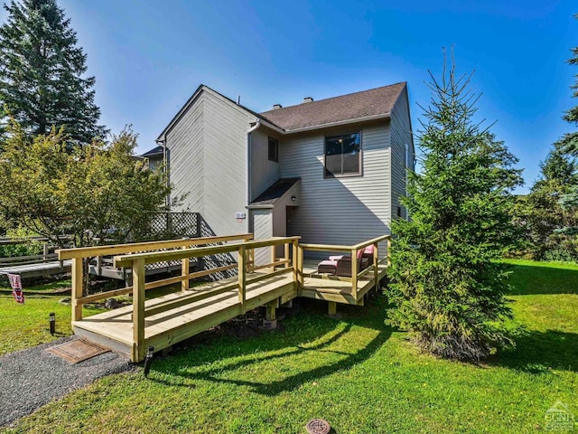 back of house with a wooden deck and a yard