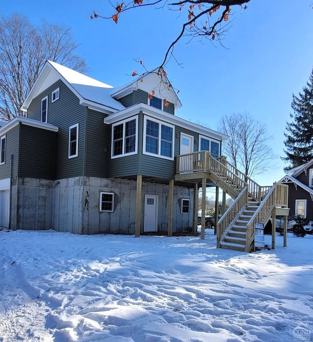 view of snow covered back of property