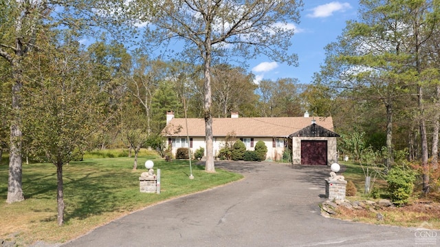 view of front of house with a front lawn and a garage