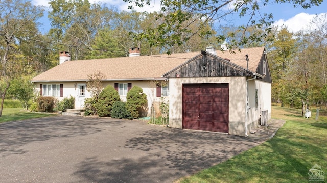 view of front of property with a garage and a front lawn