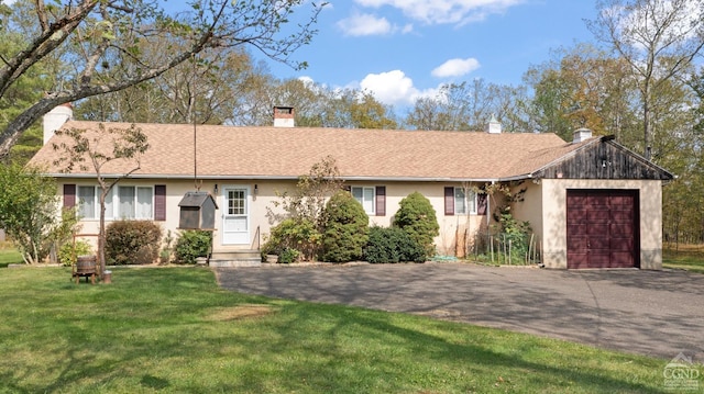 single story home with a front yard and a garage