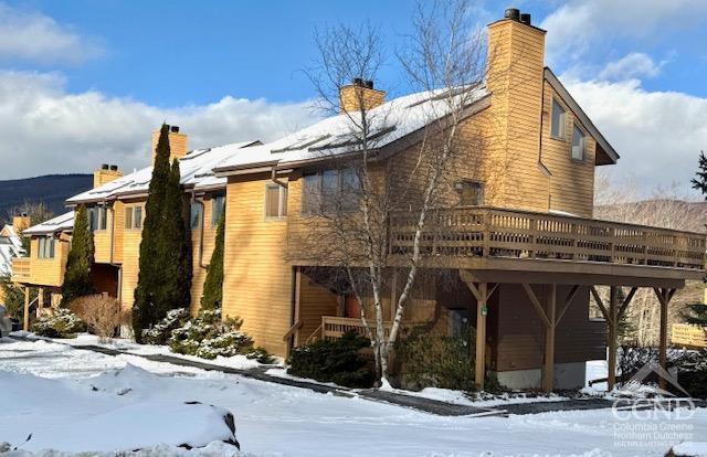 snow covered property featuring a deck