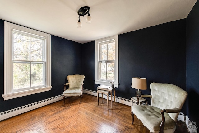 living area with parquet floors, baseboard heating, and a wealth of natural light