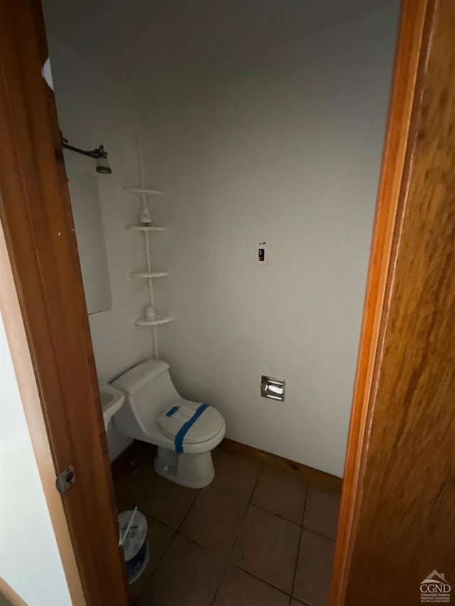 bathroom with tile patterned flooring and toilet