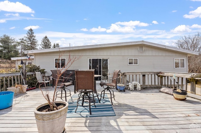 wooden terrace featuring outdoor dining area