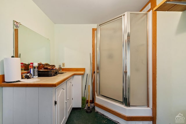 bathroom featuring a shower stall and vanity