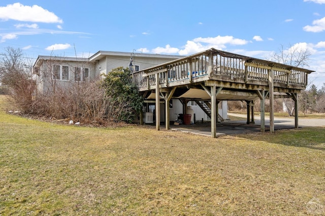 exterior space with a yard, a wooden deck, and stairs