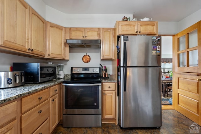 kitchen with under cabinet range hood, light brown cabinets, dark stone counters, and appliances with stainless steel finishes