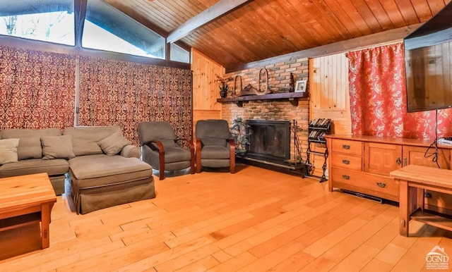 living room with lofted ceiling with beams, a healthy amount of sunlight, and light hardwood / wood-style floors