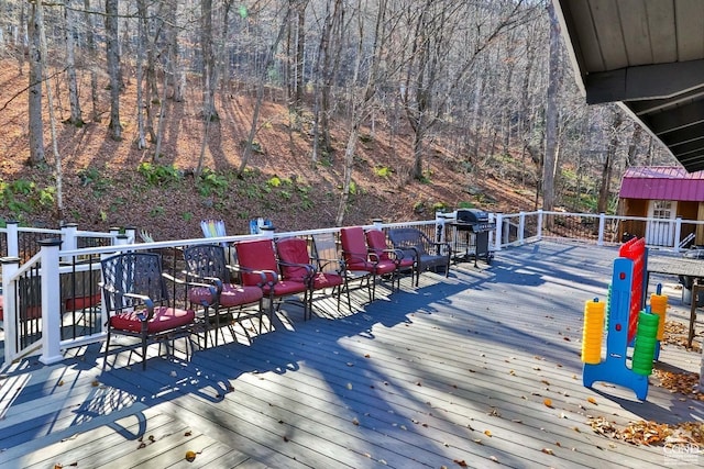 wooden terrace with a grill