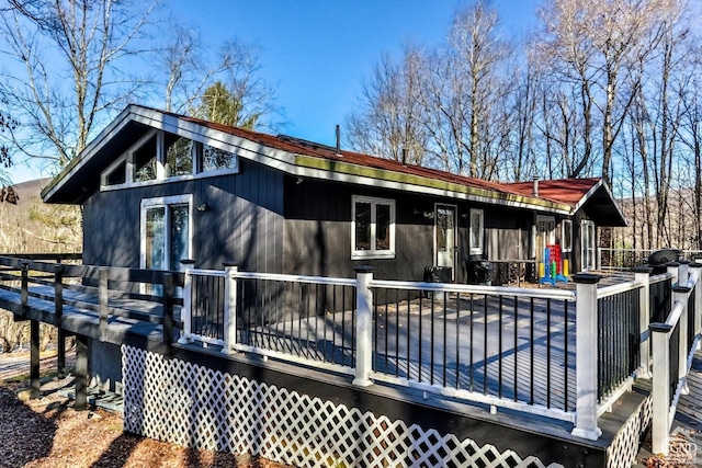 back of property featuring a deck