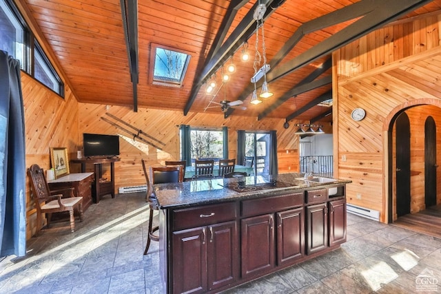 kitchen featuring a baseboard heating unit, a kitchen island, wooden walls, and wood ceiling