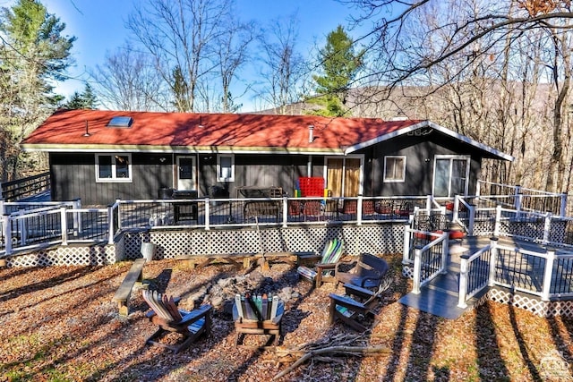 rear view of property featuring a deck