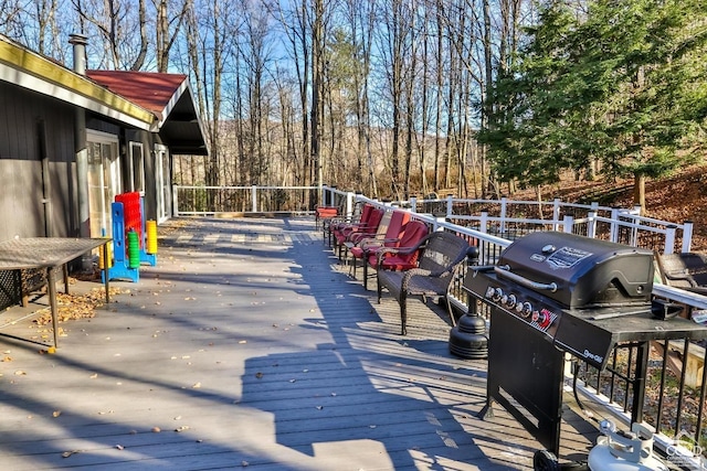 deck with outdoor lounge area and a grill