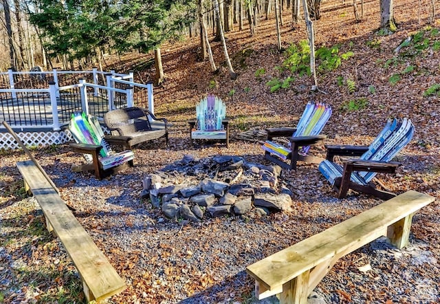 view of yard featuring an outdoor fire pit and a wooden deck