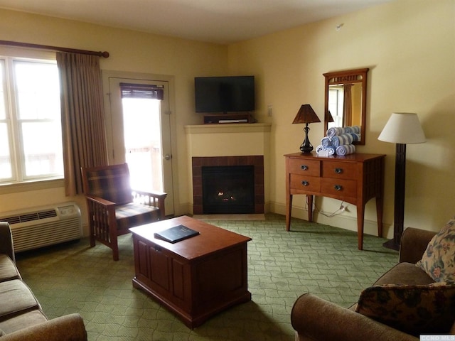 living room featuring a wall unit AC, a tiled fireplace, and light carpet