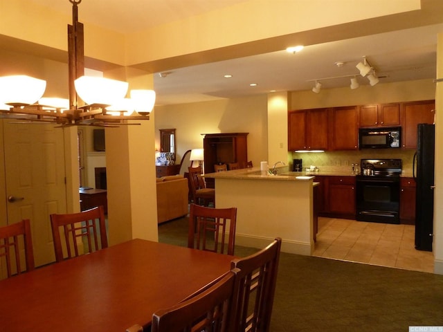 dining area with light tile patterned flooring and a chandelier