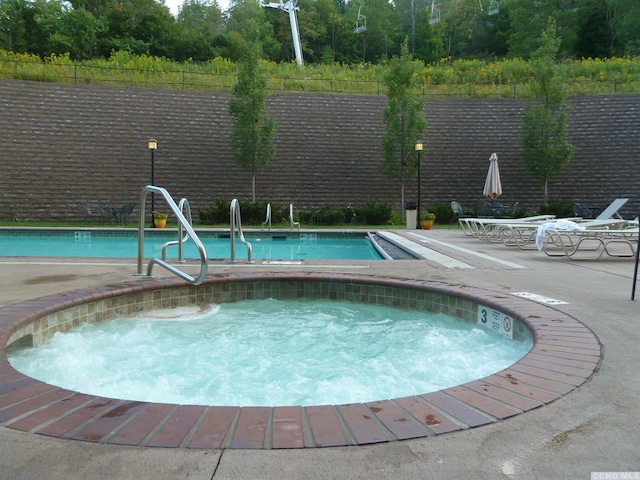 view of swimming pool featuring a community hot tub