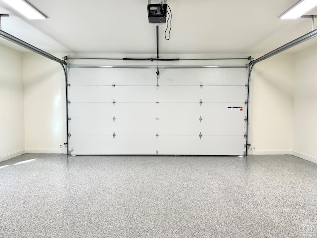 garage with baseboards and a garage door opener