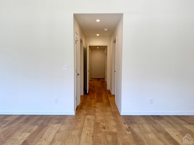 hall with recessed lighting, baseboards, and light wood finished floors