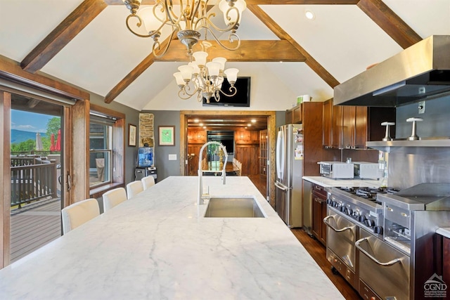 kitchen featuring sink, light stone countertops, stainless steel appliances, extractor fan, and a chandelier